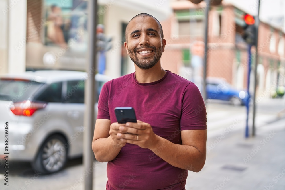 Young latin man smiling confident using smartphone at street Young latin man smiling confident using smartphone at street