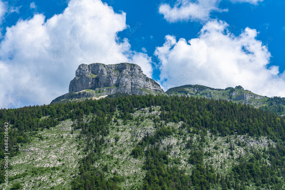 Stunning view of the steep cliff of peak Loser above Altaussee lake on a sunny summer day with blue sky cloud, Salzkammergut-Ausseerland region, Styria, Austria