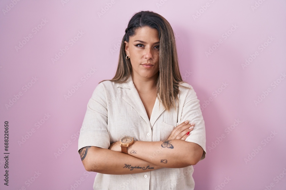 Blonde woman standing over pink background skeptic and nervous, disapproving expression on face with crossed arms. negative person. Blonde woman standing over pink background skeptic and nervous, disapproving expression on face with crossed arms. negative person.