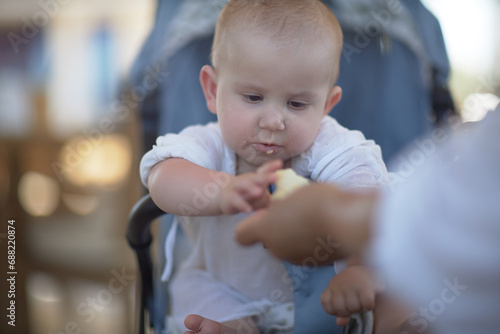 A small child eats by himself a close-up portrait