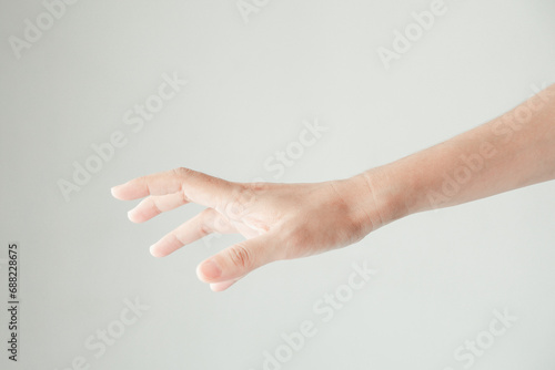 A male hand reaches for something or points to something isolated on a white background. Isolated hand reaching out. Photo for body part hand. photo