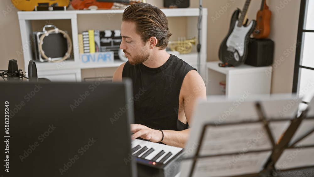 Young hispanic man musician playing piano at music studio Young hispanic man musician playing piano at music studio