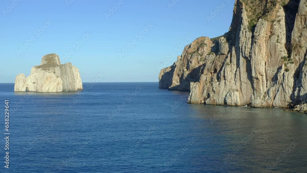 Aerial drone view of Porto Flavia mines entrance on the rocks and iconic Pan di Zucchero island in Sardinia, Italy Aerial drone view of Porto Flavia mines entrance on the rocks and iconic Pan di Zucchero island in Sardinia, Italy