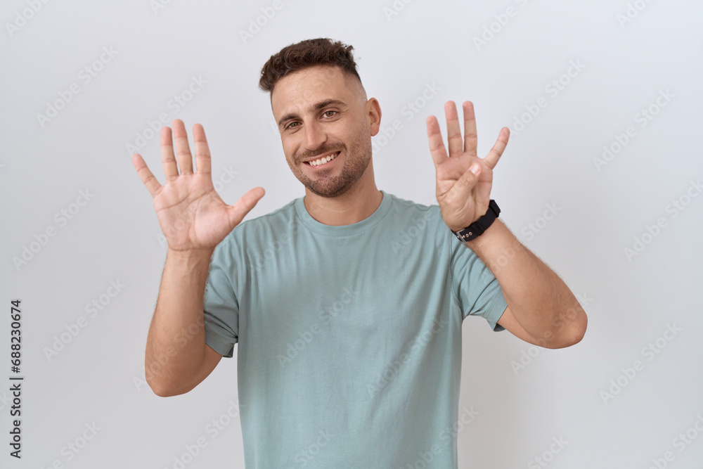 Hispanic man with beard standing over white background showing and pointing up with fingers number nine while smiling confident and happy. Hispanic man with beard standing over white background showing and pointing up with fingers number nine while smiling confident and happy.