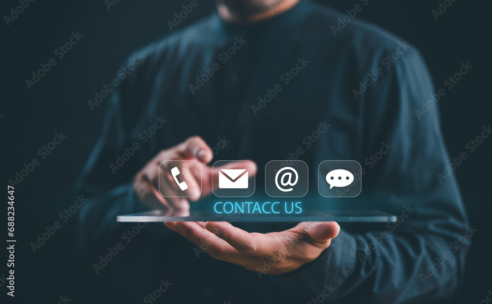 Fototapeta premium Contact us or Customer support hotline, people connect. Businessman show on virtual screen contact icons email, address, live chat, telephone. Customer service, helpdesk advice online support