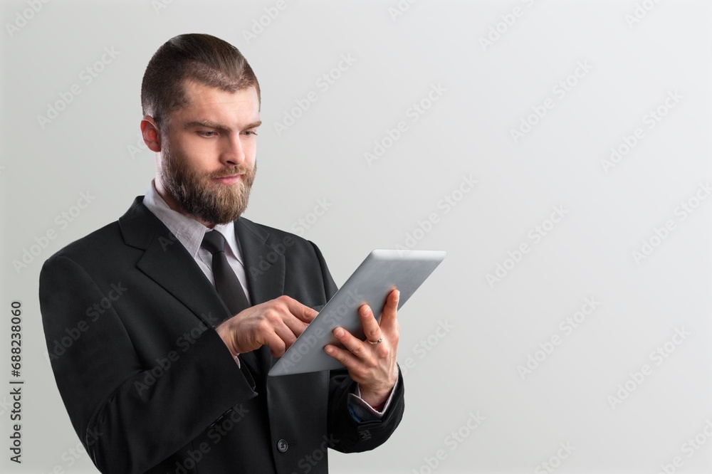 Smart caucasian freelancer professor using tablet computer Smart caucasian freelancer professor using tablet computer