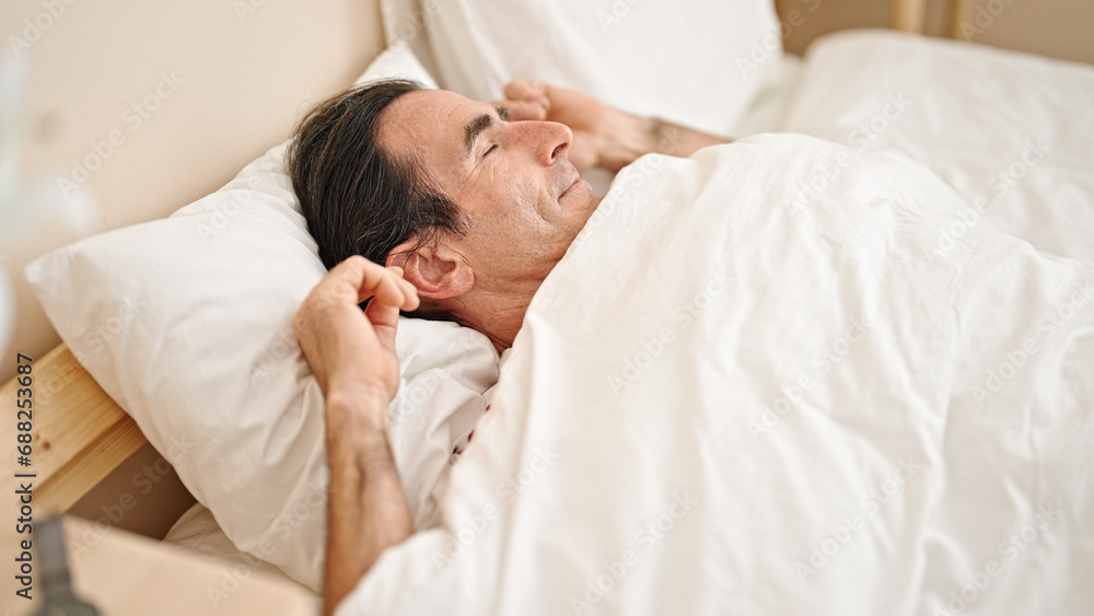 Middle age man lying on bed sleeping at bedroom Middle age man lying on bed sleeping at bedroom