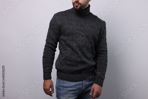 Man in stylish sweater on white background, closeup