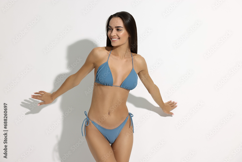 Young woman in stylish bikini on white background Young woman in stylish bikini on white background