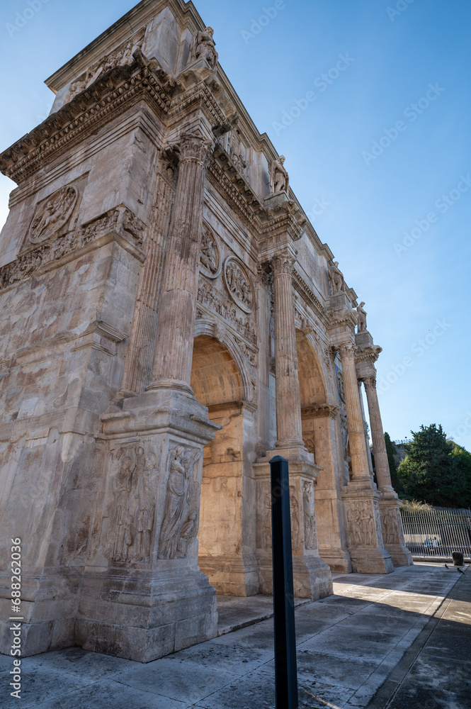 Arch of Constantine. Triumphal arch and Colosseum in the background in Rome, Italy.