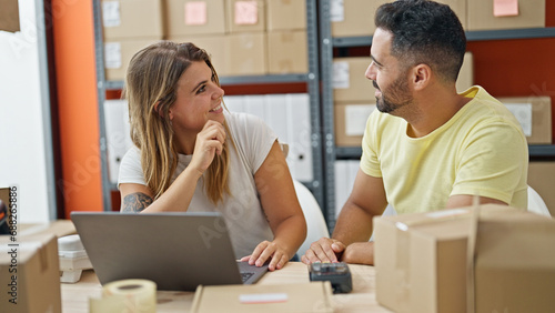 Man and woman ecommerce business workers using laptop smiling at office