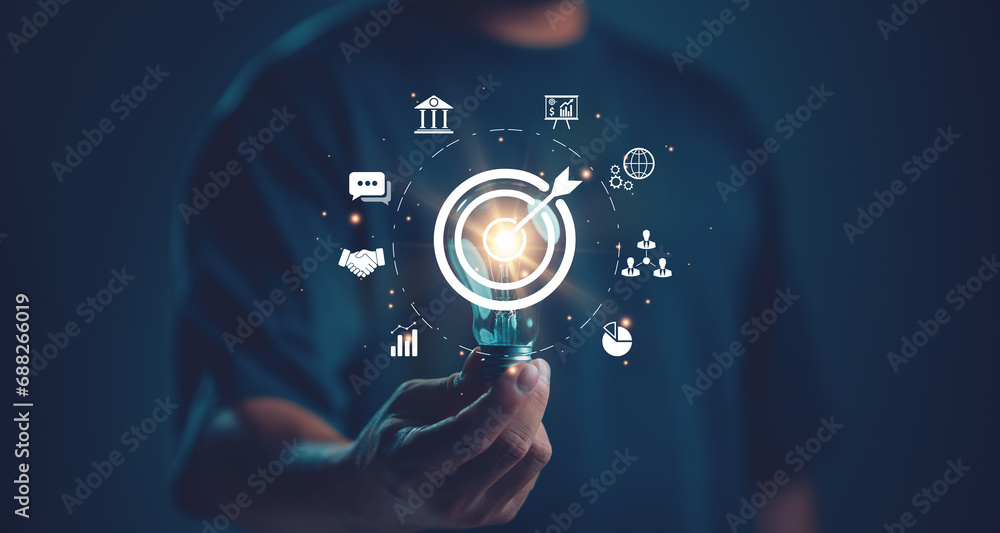 Businessman holding lightbulb with target icon. Business global internet connection application technology and digital marketing, Financial and banking, Digital link tech, big data, business target. Businessman holding lightbulb with target icon. Business global internet connection application technology and digital marketing, Financial and banking, Digital link tech, big data, business target.