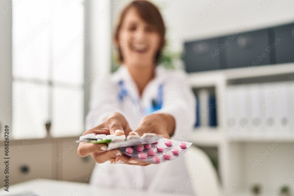 Young doctor woman holding pills smiling and laughing hard out loud because funny crazy joke. Young doctor woman holding pills smiling and laughing hard out loud because funny crazy joke.