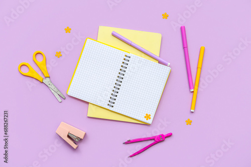 Composition with different school supplies on lilac background