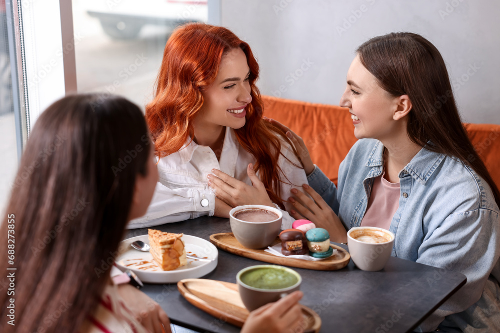Happy friends spending time together in cafe Happy friends spending time together in cafe