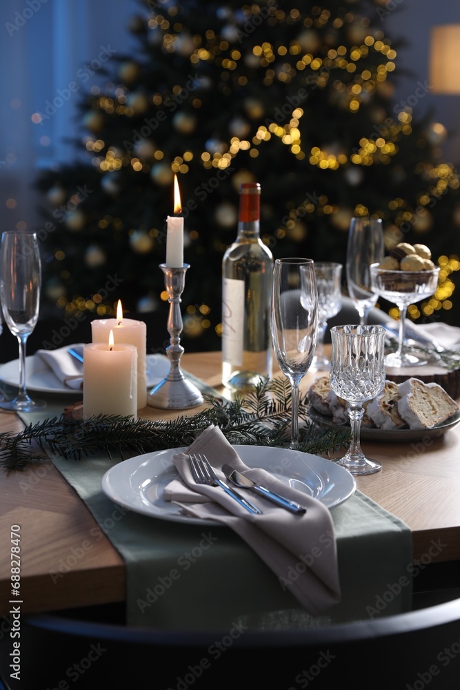 Christmas table setting with festive decor and dishware indoors Christmas table setting with festive decor and dishware indoors