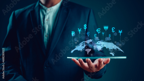 Global business and Global currency exchange concept, money, finance, Businessman holding tablet with virtual world map and connection line effect, dollar yuan yen euro and pound sterling sign. photo