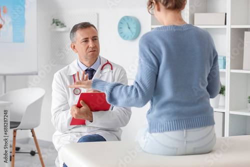 Mature doctor working with ...