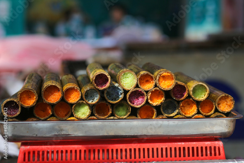 Closeup of colorful bamboo tube rice on the street in the coutryside photo