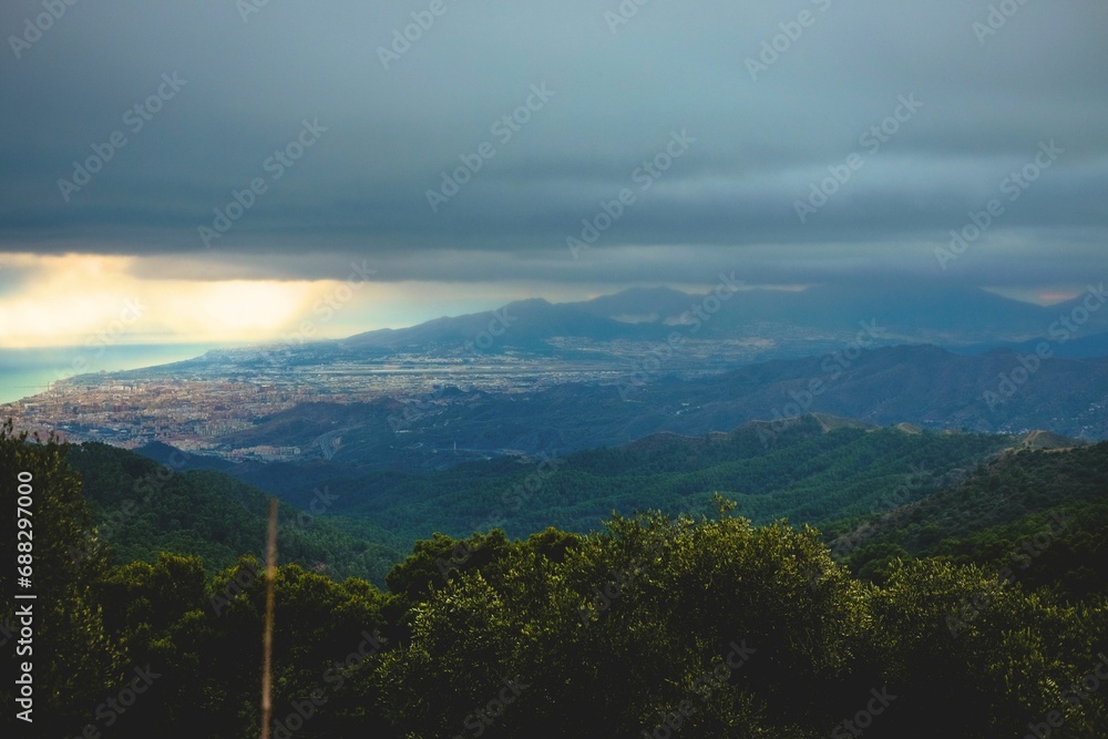 Heavy rain clouds on background of mountains and forest, Spain