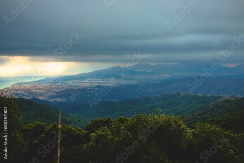 Heavy rain clouds on background of mountains and forest, Spain