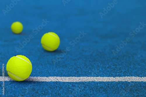 three yellow tennis  balls at sport court