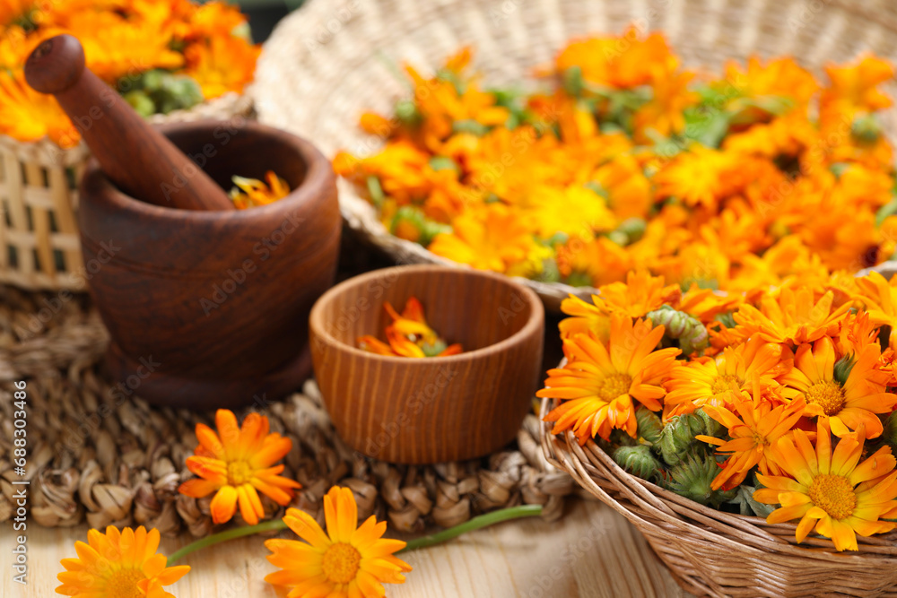 Many beautiful fresh calendula flowers on table Many beautiful fresh calendula flowers on table