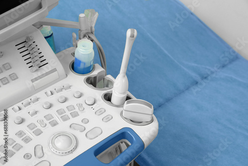 Ultrasound control panel and examination table in hospital, closeup