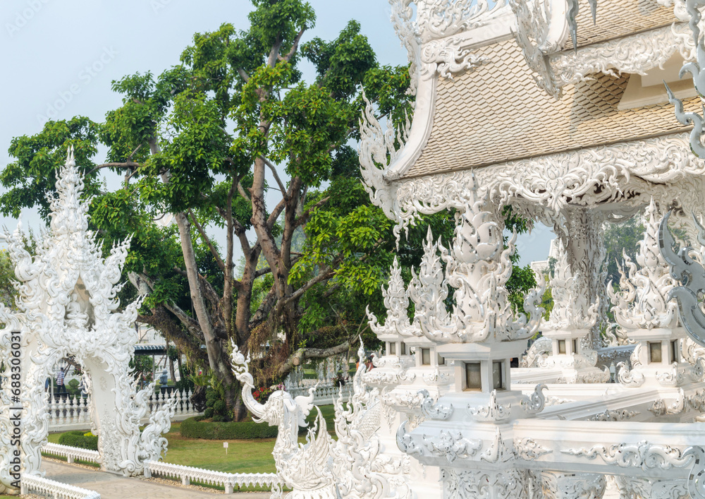 Amongst surreal structures,in the grounds of Wat Rong Khun,fantastical White Temple,Chiang Rai Province,Northern Thailand.