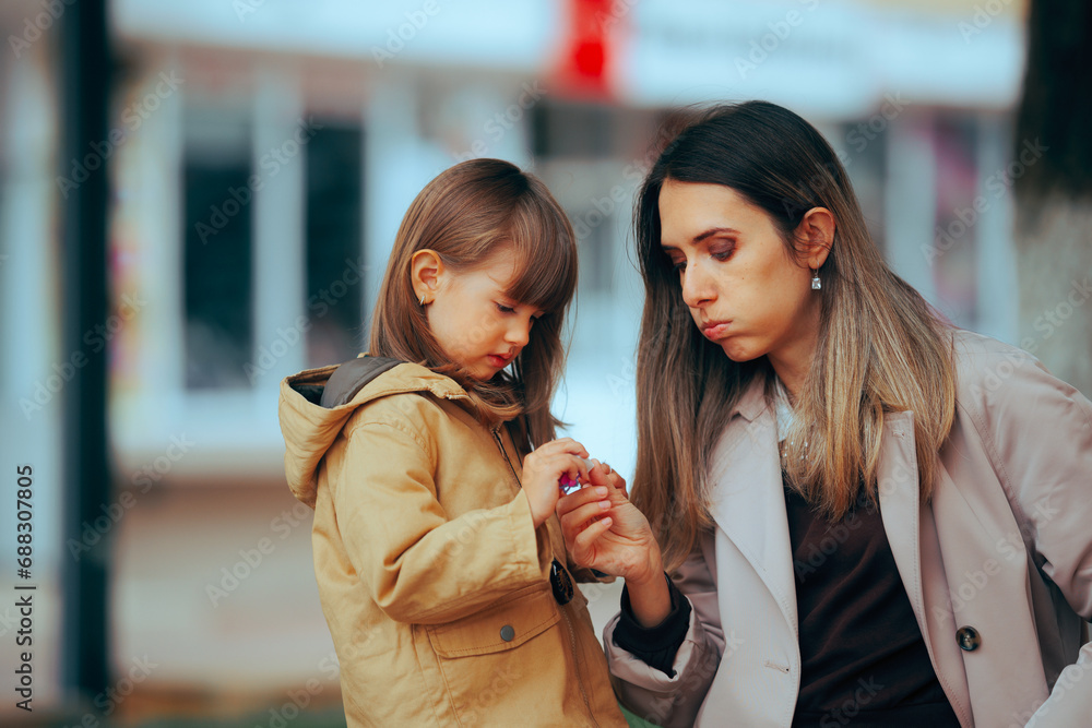 Skeptical Mom Giving Candies to her Little Girl. Mother giving small