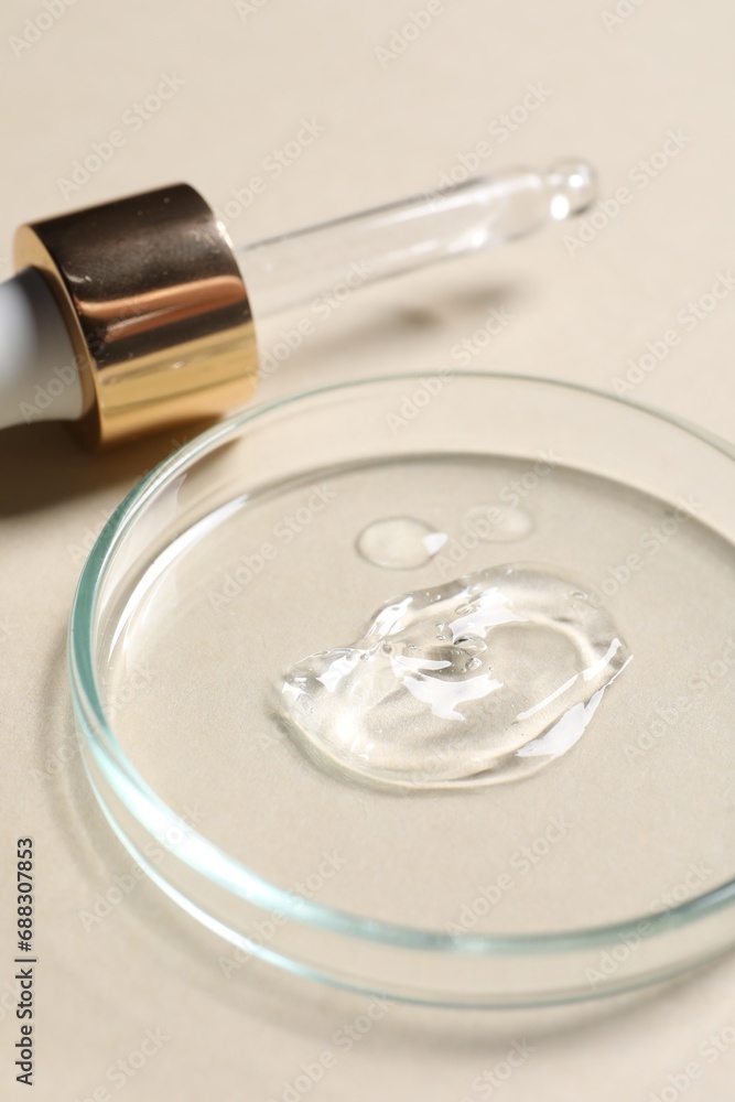 Pipette and petri dish with sample of cosmetic serum on beige background, closeup Pipette and petri dish with sample of cosmetic serum on beige background, closeup