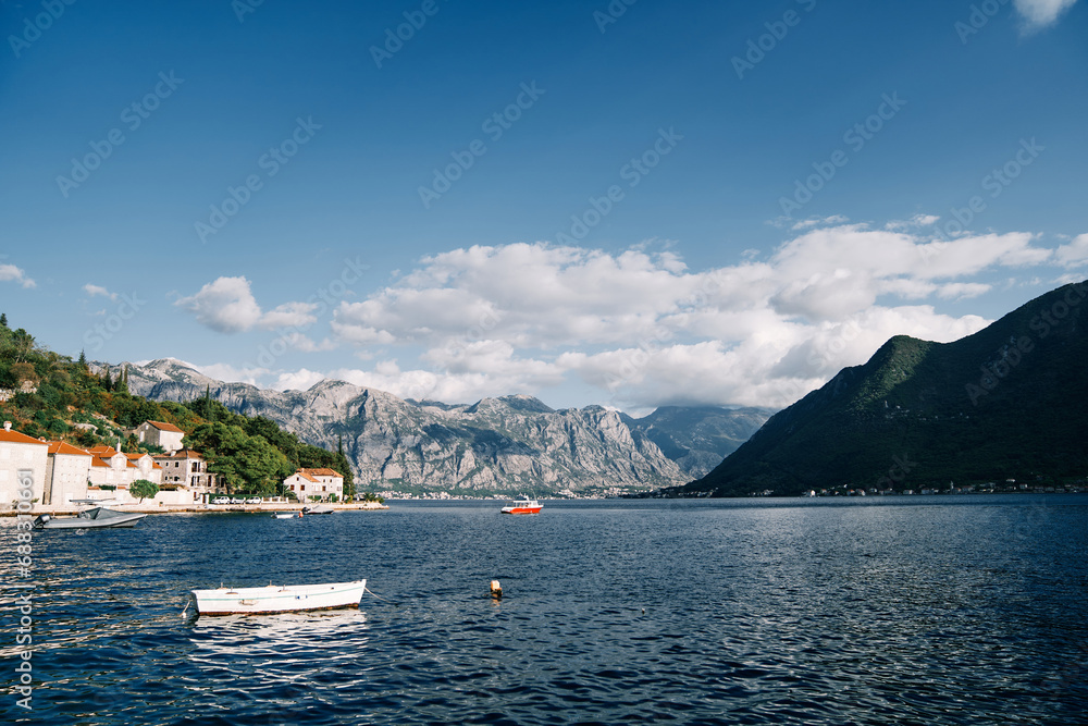 White fishing boat is moored in the sea off the coast of Perast. Montenegro