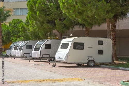 Several motorhome trailers parked in a residential area.