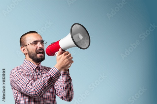 Happy young man scream in megaphone