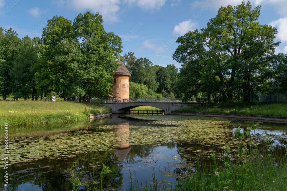 Slavyanka River and the Pill Tower Bridge in the Pavlovsk Palace and Park Complex on a sunny summer day, Pavlovsk, Saint Petersburg, Russia Slavyanka River and the Pill Tower Bridge in the Pavlovsk Palace and Park Complex on a sunny summer day, Pavlovsk, Saint Petersburg, Russia