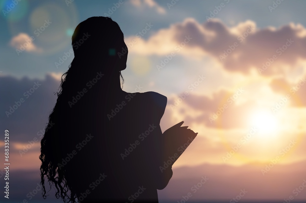 person reads holly bible book at sunset. person reads holly bible book at sunset.