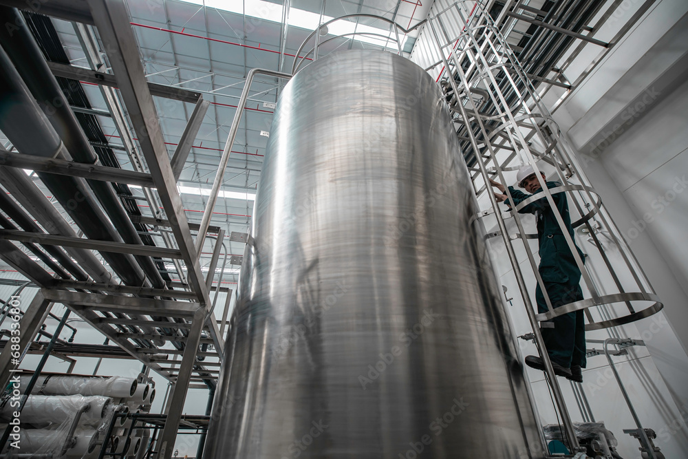 The male worker down the ladder is for inspection stainless steel tank chemical. The male worker down the ladder is for inspection stainless steel tank chemical.