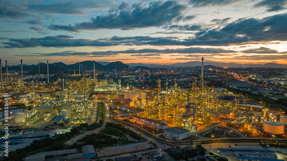 Aerial view of the morning of the oil refinery from the drone of the tower of the Petrochemistry industry in the oil​ and​ gas​ ​industry with​ cloud​ sun orange​