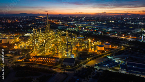 Aerial view of the morning of the oil refinery from the drone of the tower of the Petrochemistry industry in the oil​ and​ gas​ ​industry with​ cloud​ sun orange​