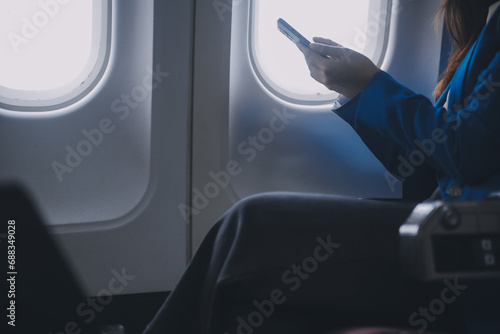 Using mobile and laptop, Thoughtful asian people female person onboard, airplane window, perfectly capture the anticipation and excitement of holiday travel. chinese, japanese people.