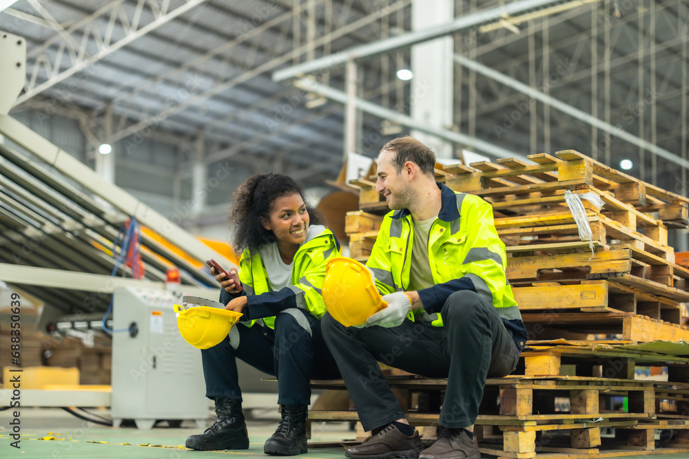 Fototapeta premium Cardboard workers chat, share ideas during breaks, foster togetherness, create positive workspace.