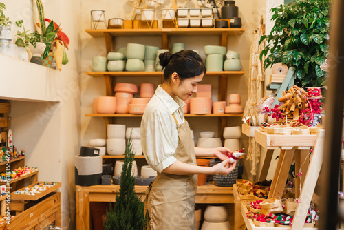 Print op canvas Portrait of Asian woman working in a plant shop