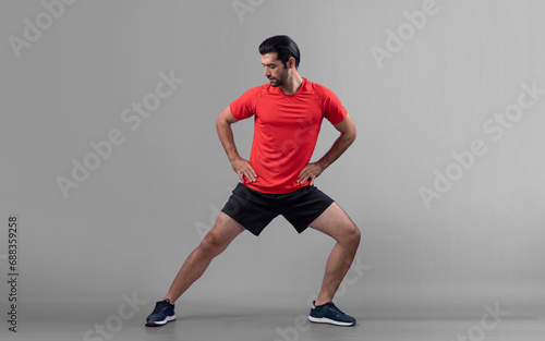 Full body length gaiety shot athletic and sporty young man with fitness warmup and stretching body for pre exercise posture on isolated background. Healthy active and body care lifestyle. © Summit Art Creations