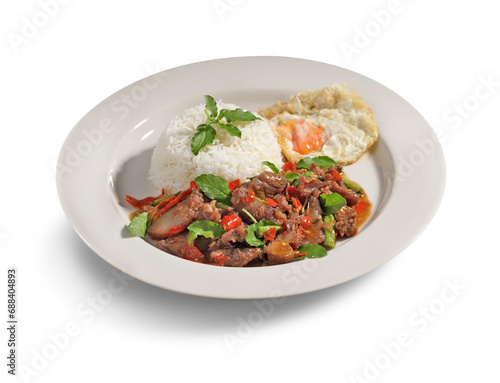 Stir fried basil and meat on rice with fried egg in white dish on white background