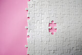 White jigsaw puzzle pattern missing pieces on pink background. Concept for expressing problem success solution alliance union teamwork