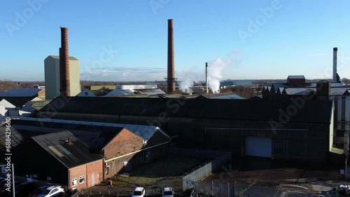 Pilkington glass factory warehouse buildings aerial dolly view across industrial town manufacturing facility photo