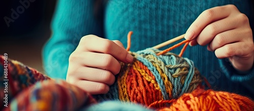 Close-up of knitting hand with yarn photo