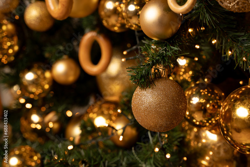 A golden sparkling ball on a Christmas tree