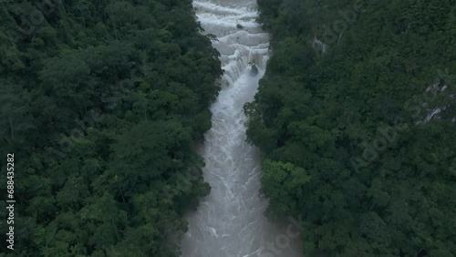 Reveal shot of brown Semuc champey waterfall at Guatemala, aerial photo