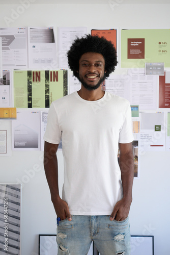 portrait of a black entrepreneur with afro and casual look smiling, Moodboard of projects in the background photo